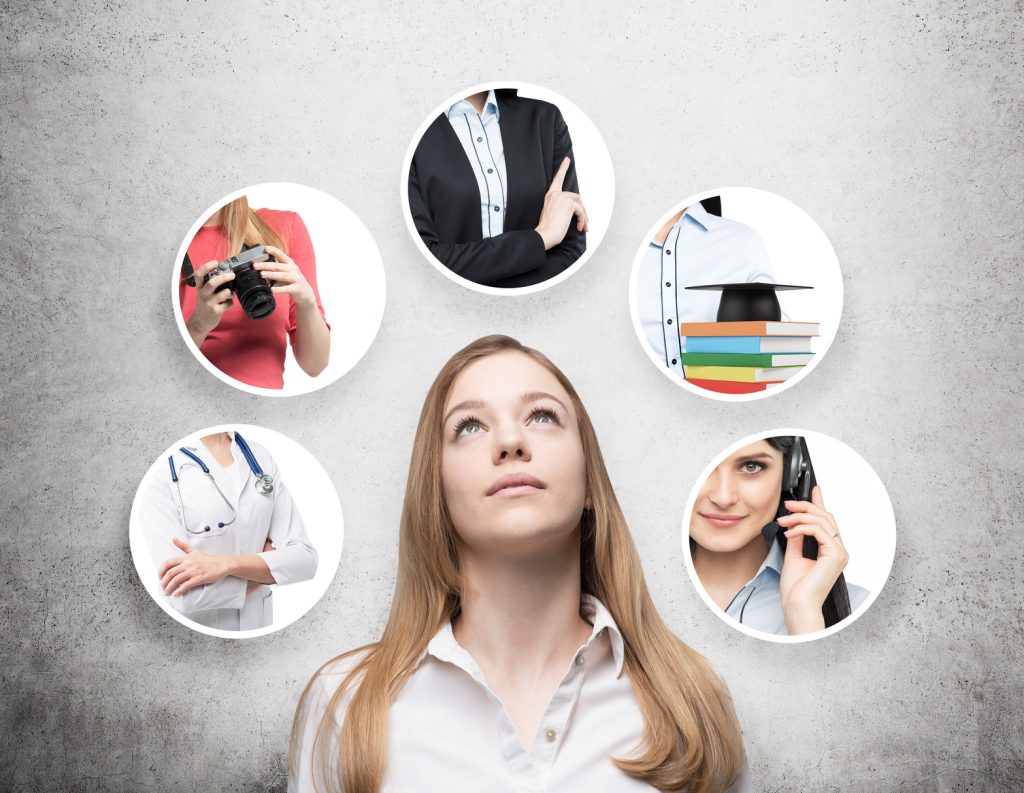 a beautiful young lady in a formal shirt is thinking about different professions. concrete background.