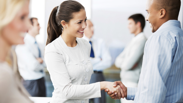business man and woman shaking hands.