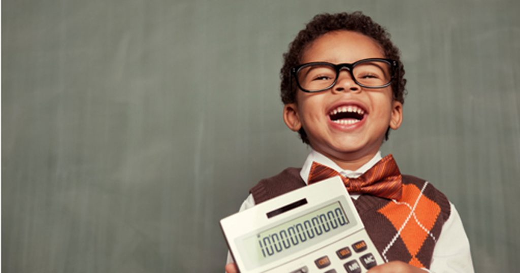 young nerd boy wearing glasses holding calculator