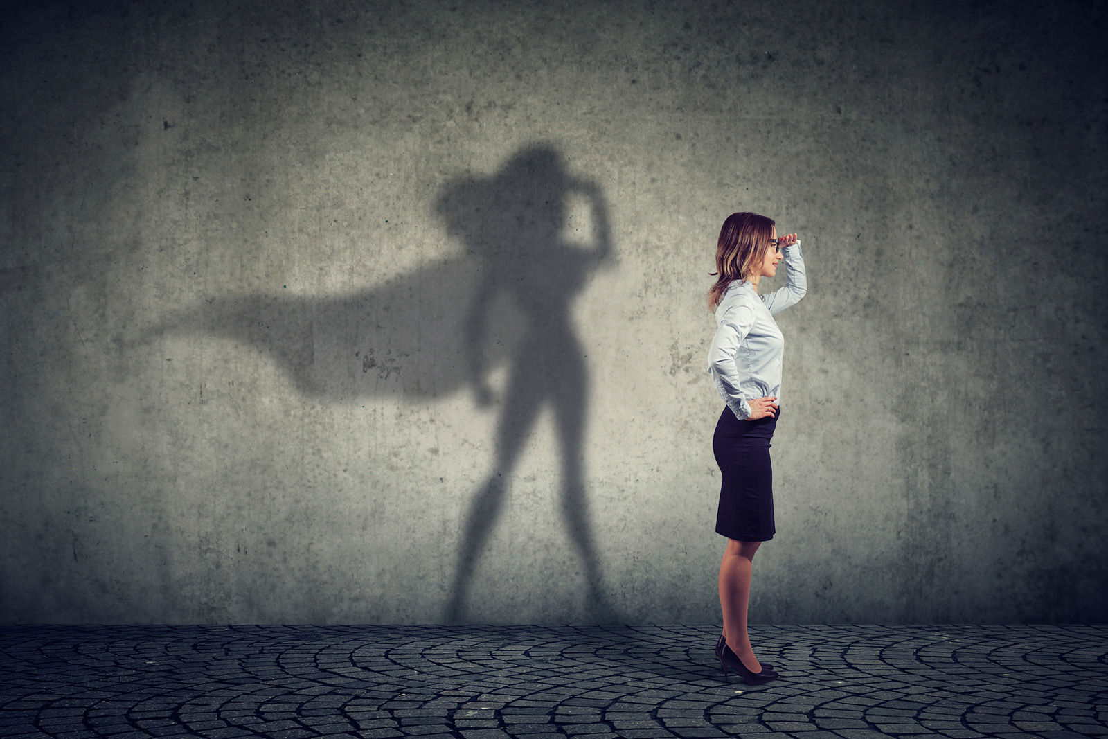 side view of a business woman imagining to be a super hero looki