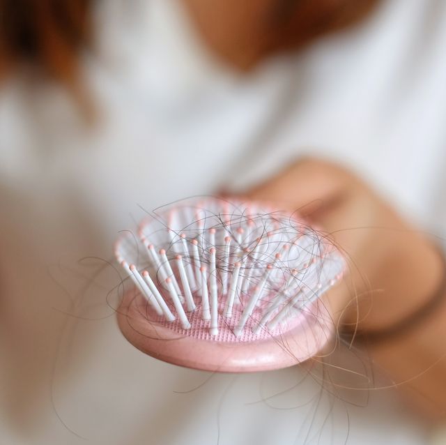 midsection of woman hairbrush with fallen hair royalty free image 1596566393