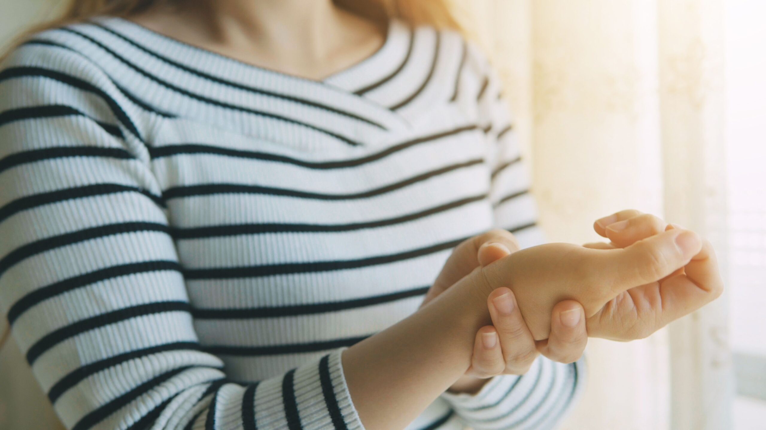 woman massaging her arthritic hand and wrist royalty free image 1596750756