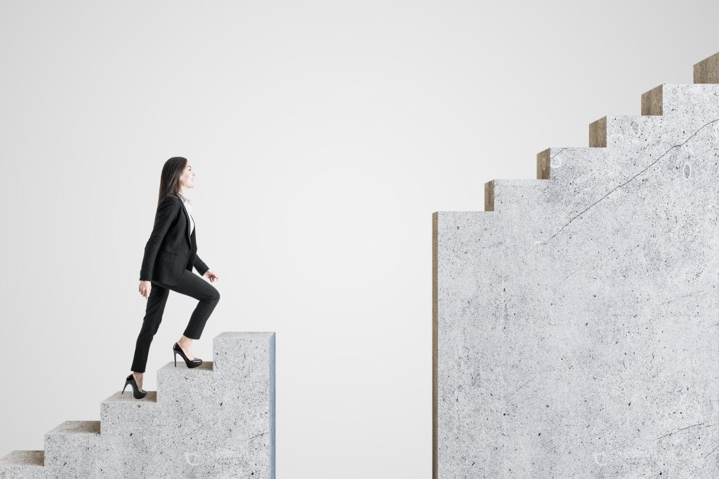 businesswoman walking on intermittent concrete staircase