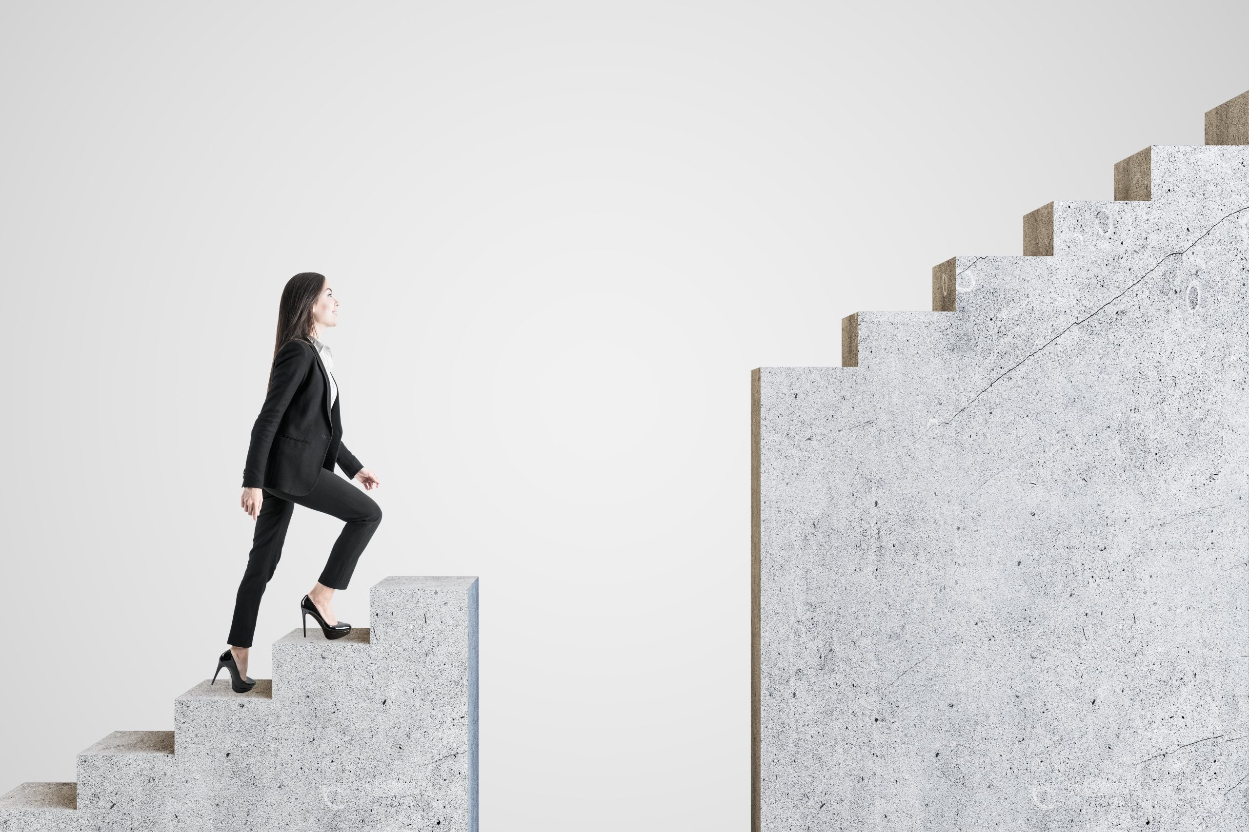 businesswoman walking on intermittent concrete staircase